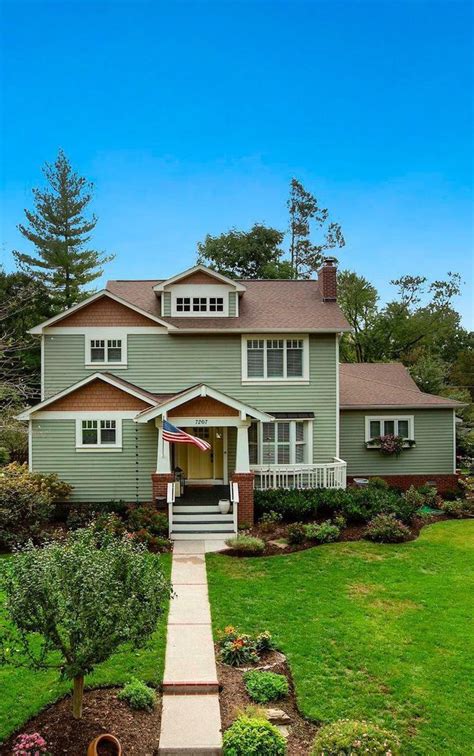 green siding with brown roof